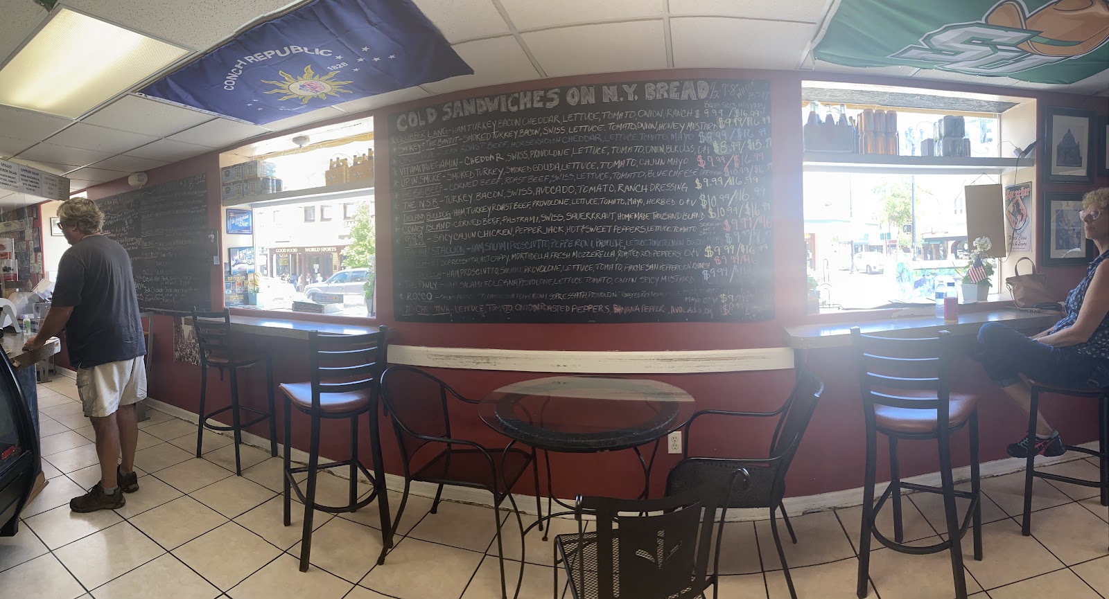 Inside Manzano's Deli, with the cold sandwich chalkboard menu
